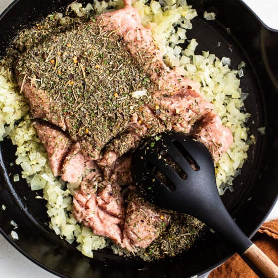 A cast iron skillet filled with herbs and spices.