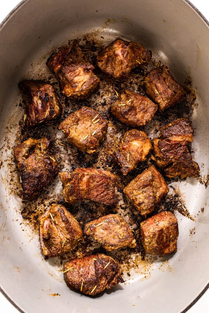 Browned beef chunks in a pot. 