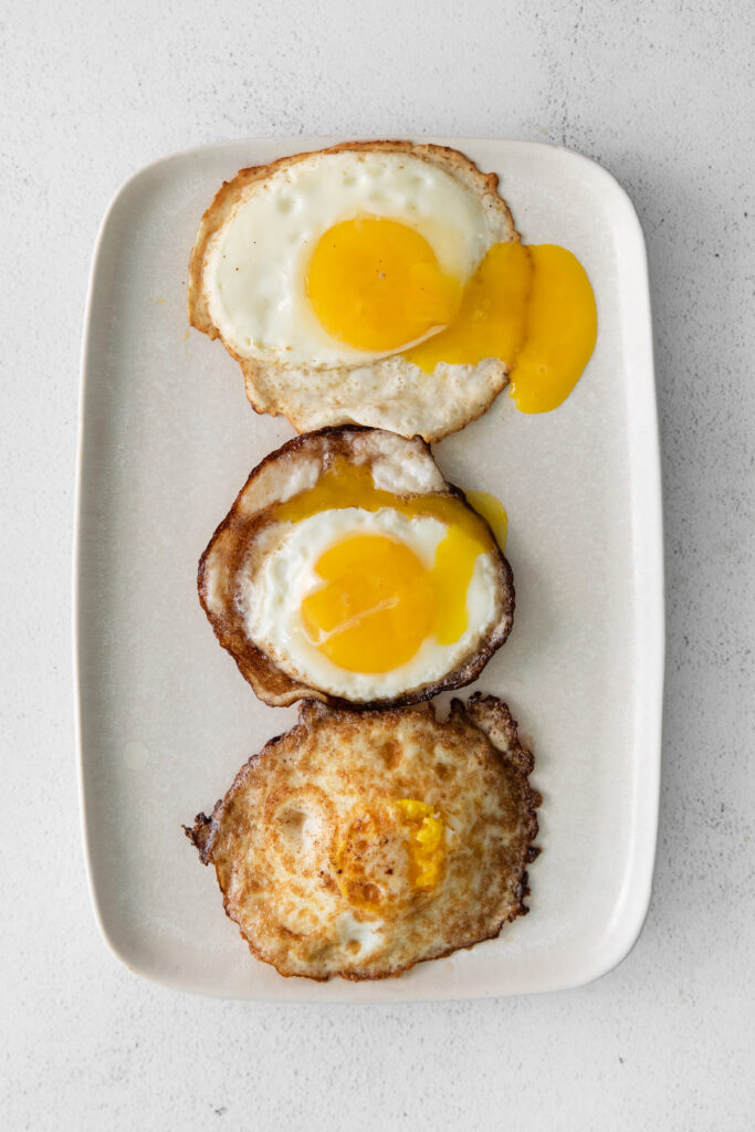 Over easy, over medium, and over hard eggs on a platter. 