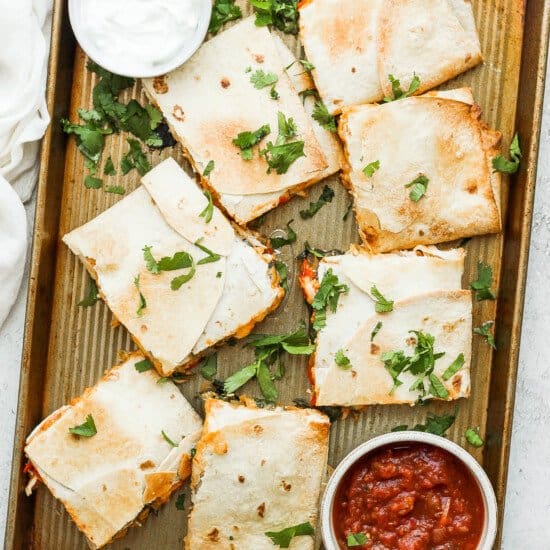 Cut the quesadilla into squares and top with your favorite toppings.