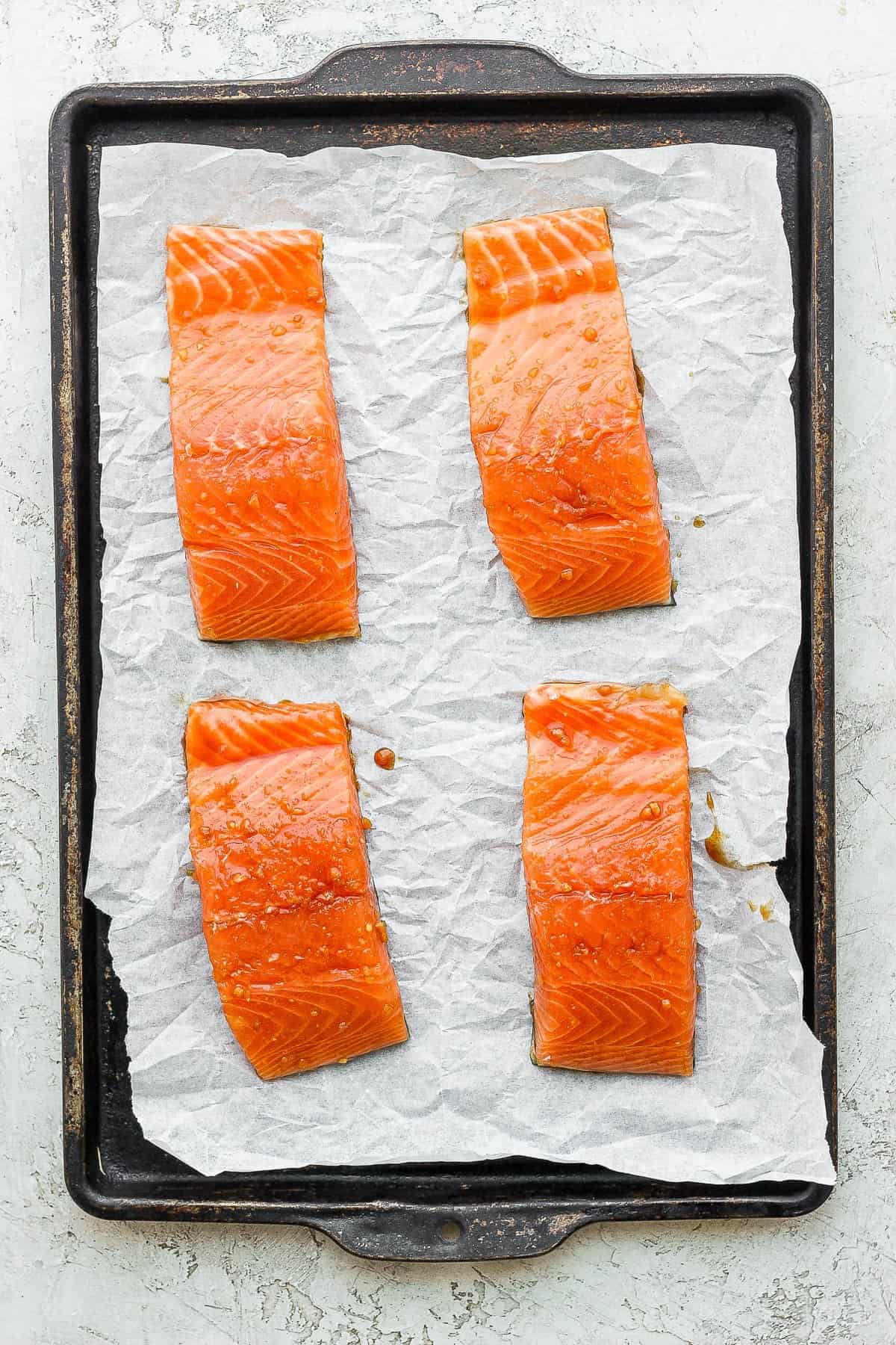 salmon filets on baking sheet