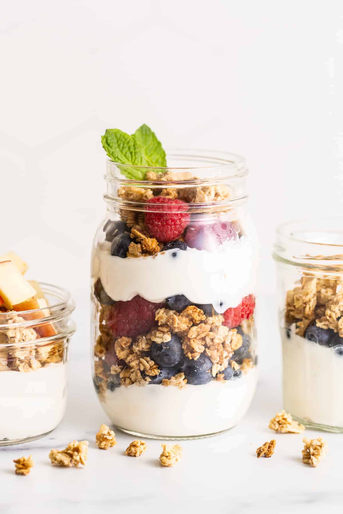 yogurt parfait in a mason jar topped with fresh mint