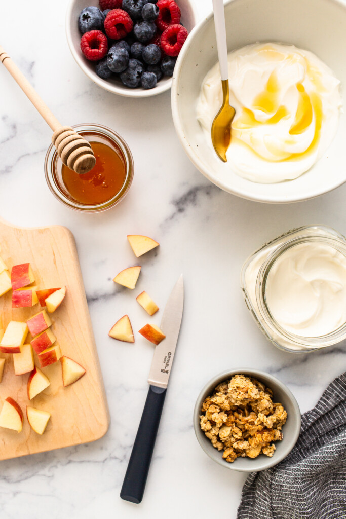 ingredients for a yogurt parfait in bowls