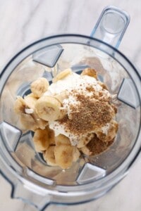 a blender filled with bananas and whipped cream, creating a mouthwatering banana smoothie.