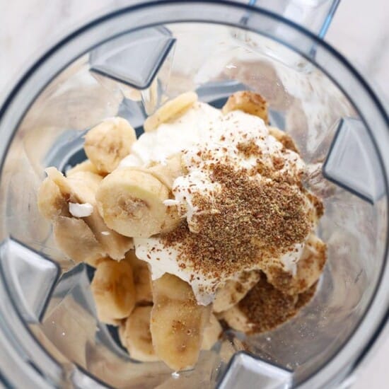 a blender filled with bananas and whipped cream, creating a mouthwatering banana smoothie.