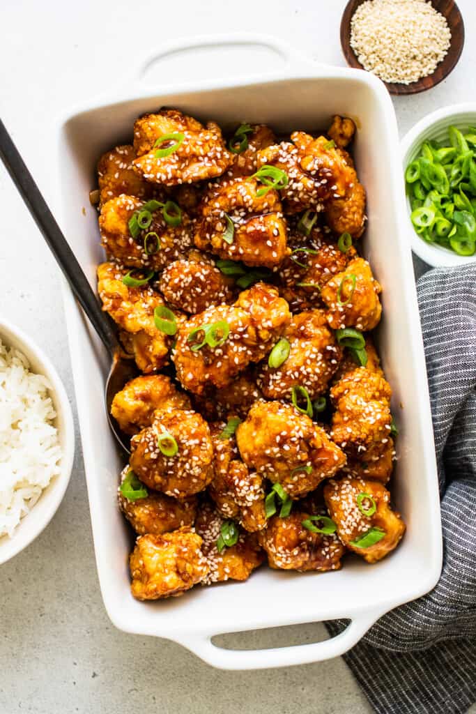 honey sesame chicken in dish with sesame seeds