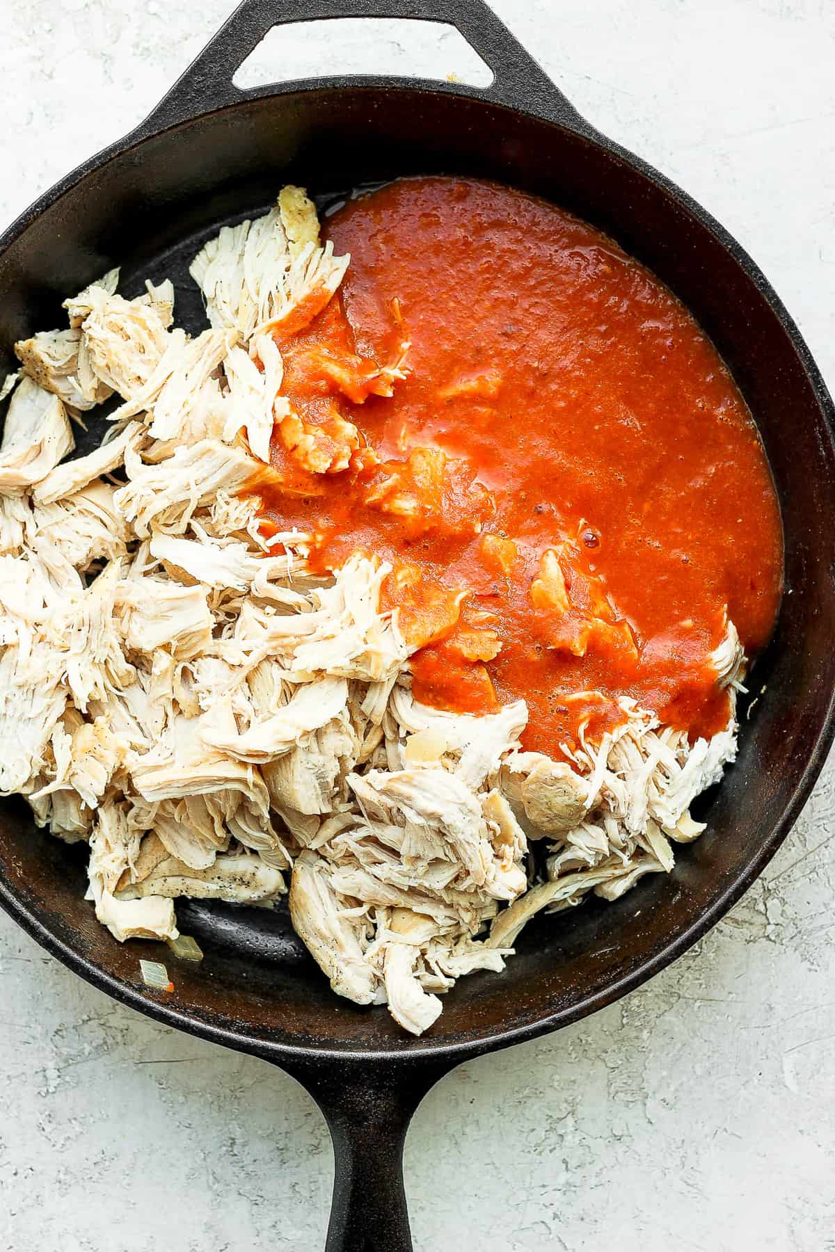 Chicken tinga in a cast iron skillet.