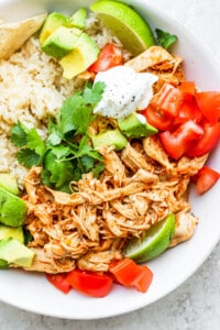 A white bowl with rice and chicken tinga.