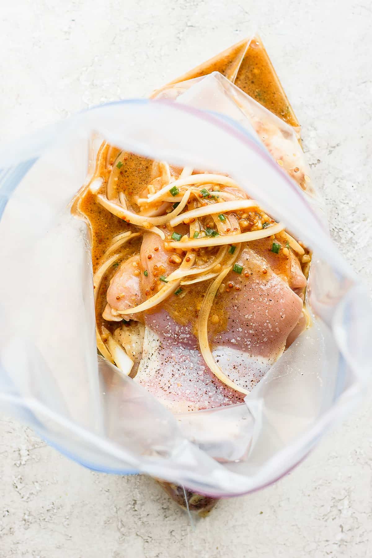 Chicken thighs and marinade in a gallon size bag.