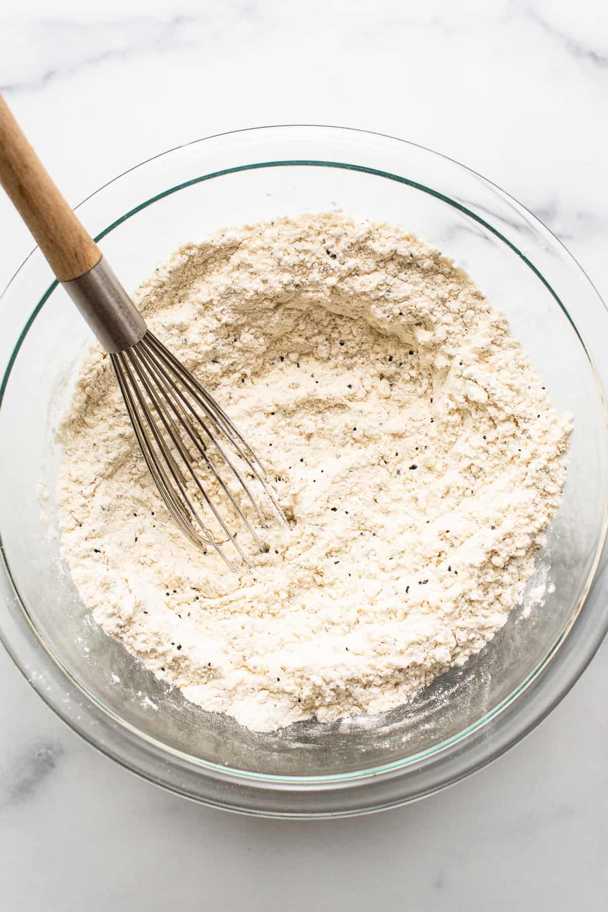 The dry ingredients for lemon poppy seed bread in a bowl. 