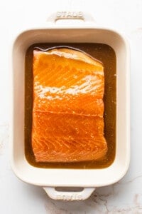 Maple mustard smoked salmon marinating in a dish.