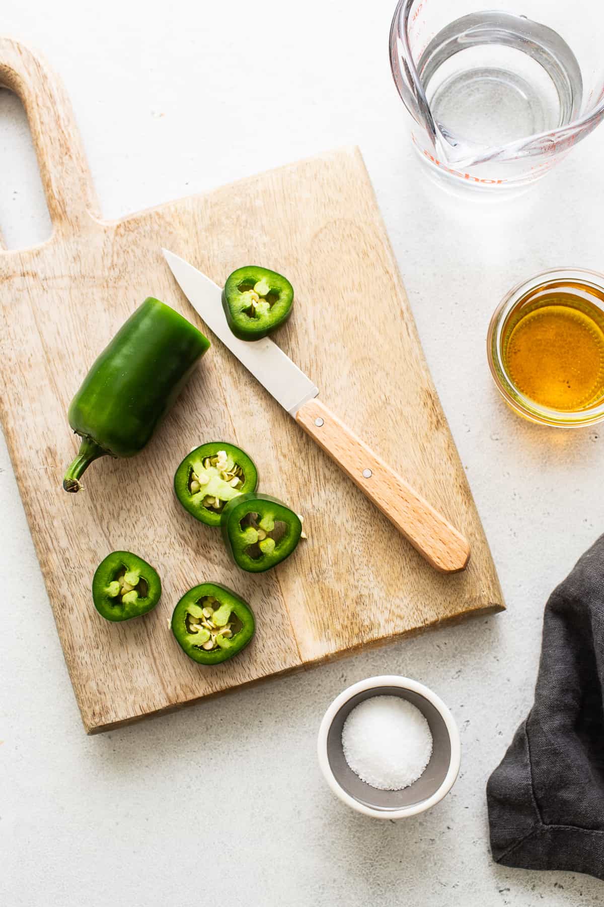 Sliced jalapeno on a cutting board.