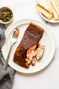 Salmon on plate with fork.