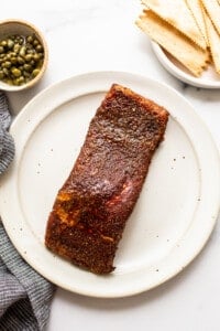 Smoked salmon resting on a plate.