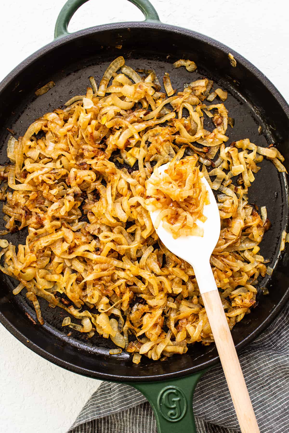 Browned caramelized onions in a skillet.