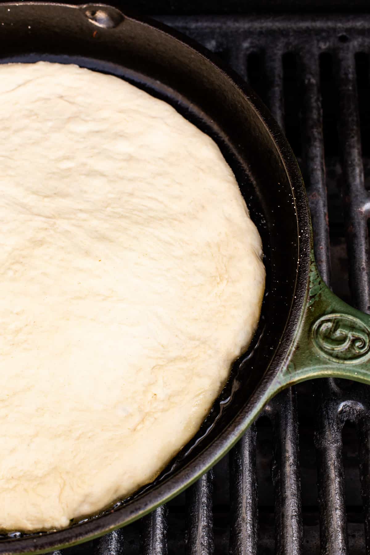 cooking pizza crust in cast iron.