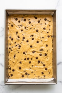 Chocolate chip cookie bars in a baking pan.