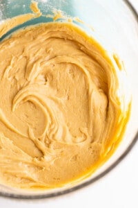 A bowl of peanut butter batter in a glass bowl.