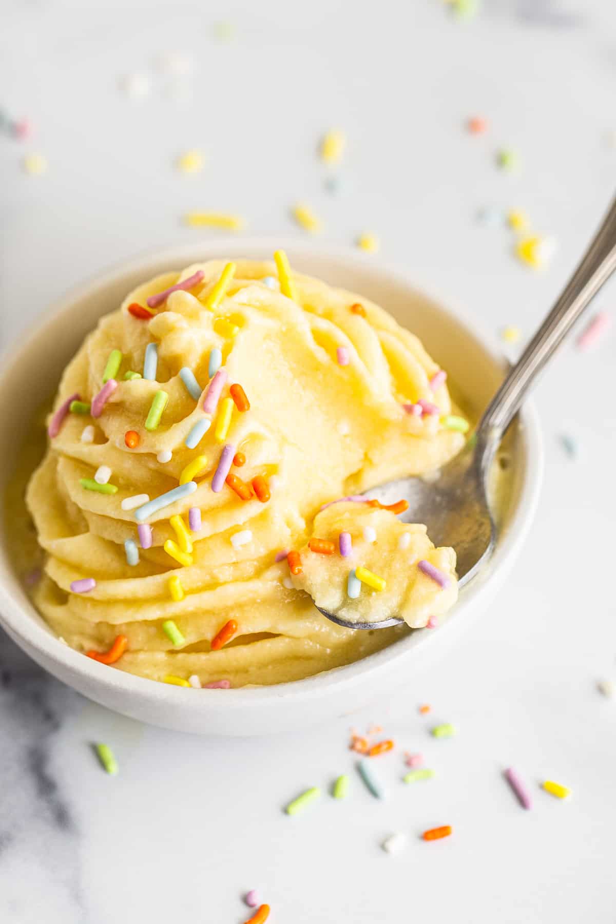 Dole Whip in a bowl with a spoon.