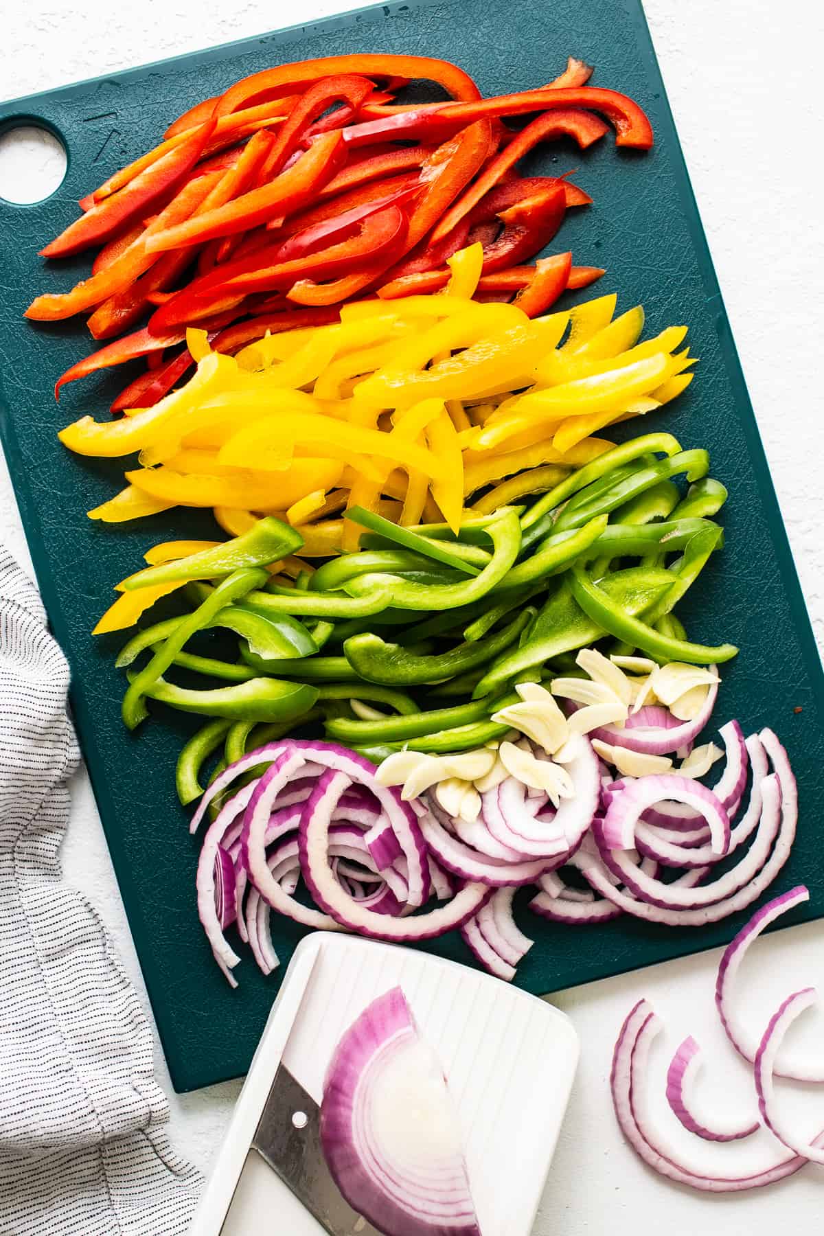 peppers and onions on cutting board.