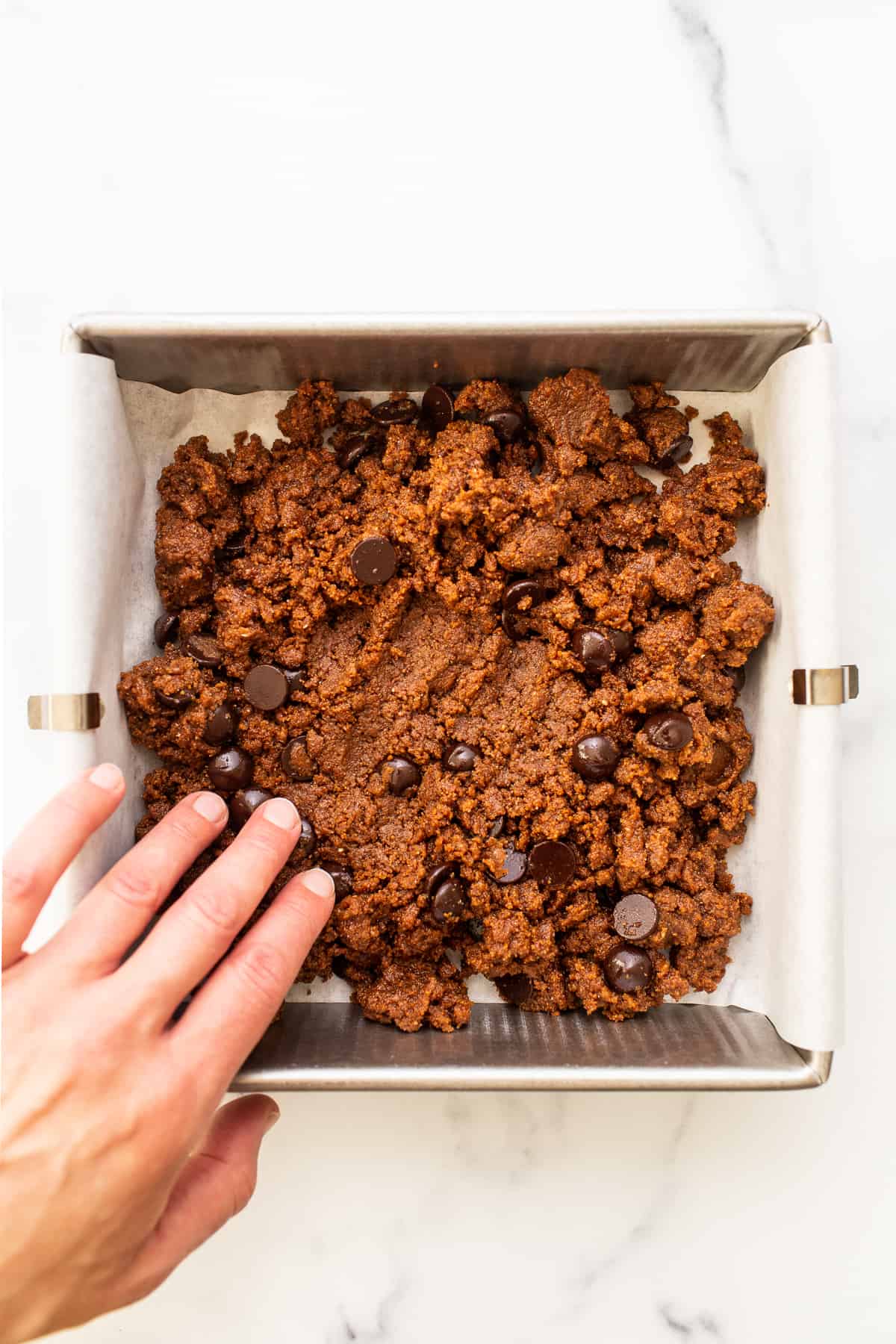 Pressing dough into pan.