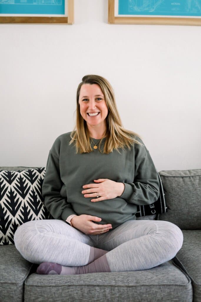 Pregnant woman sitting on a couch.