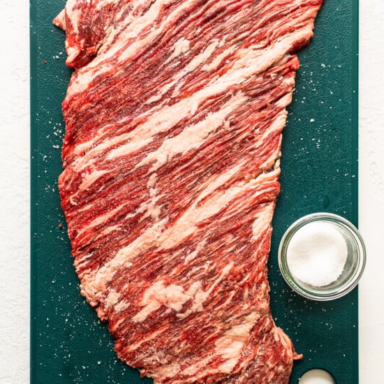 A piece of beef on a cutting board.