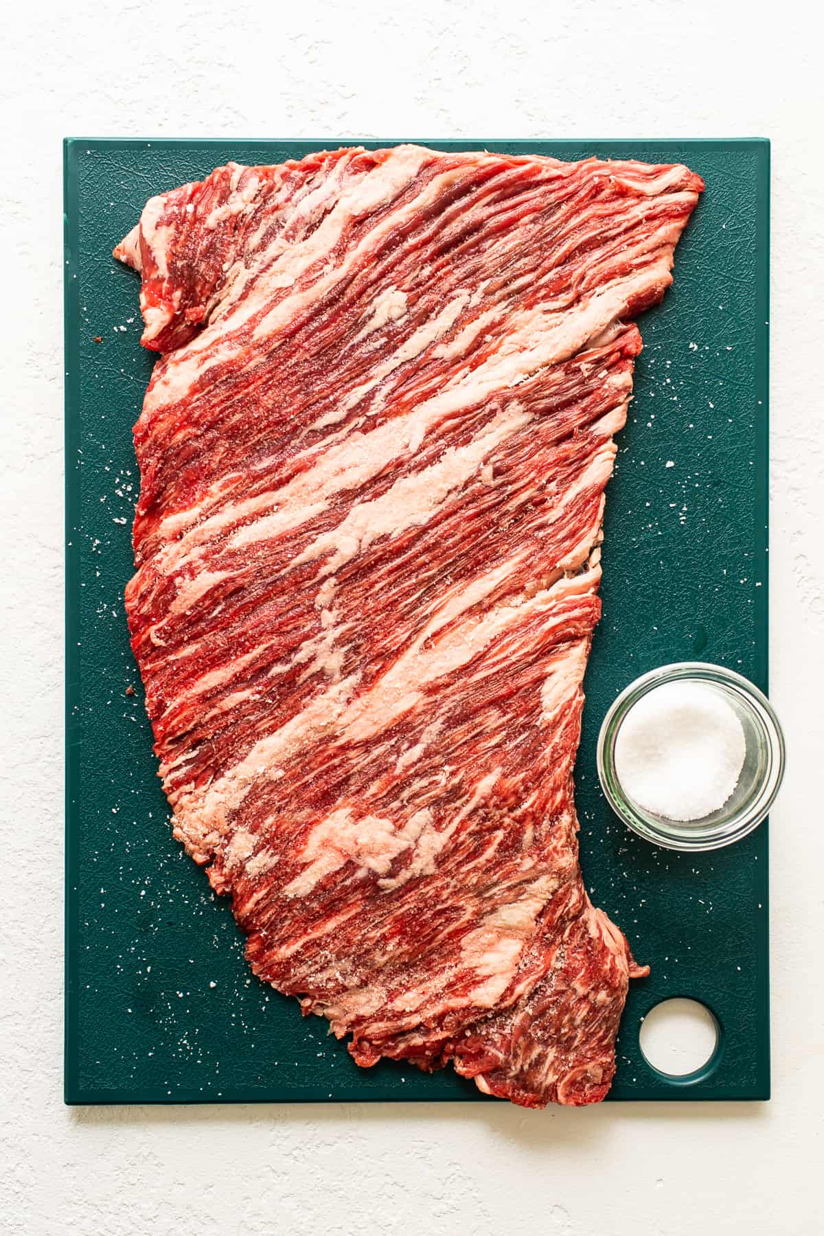 Flank steak on a cutting board.