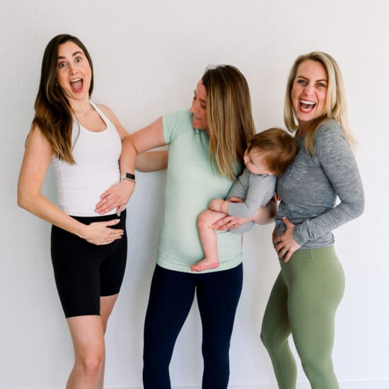 Three women in lululemon leggings, with a baby in their arms.