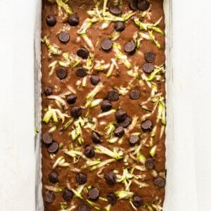 A baking pan filled with chocolate chips and green chile.