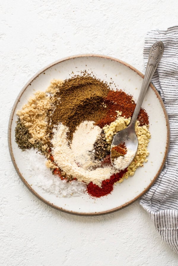 Spices on a plate with a spoon.
