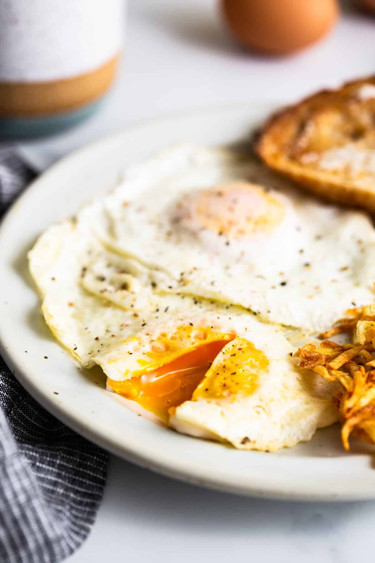 Over medium eggs on a plate.