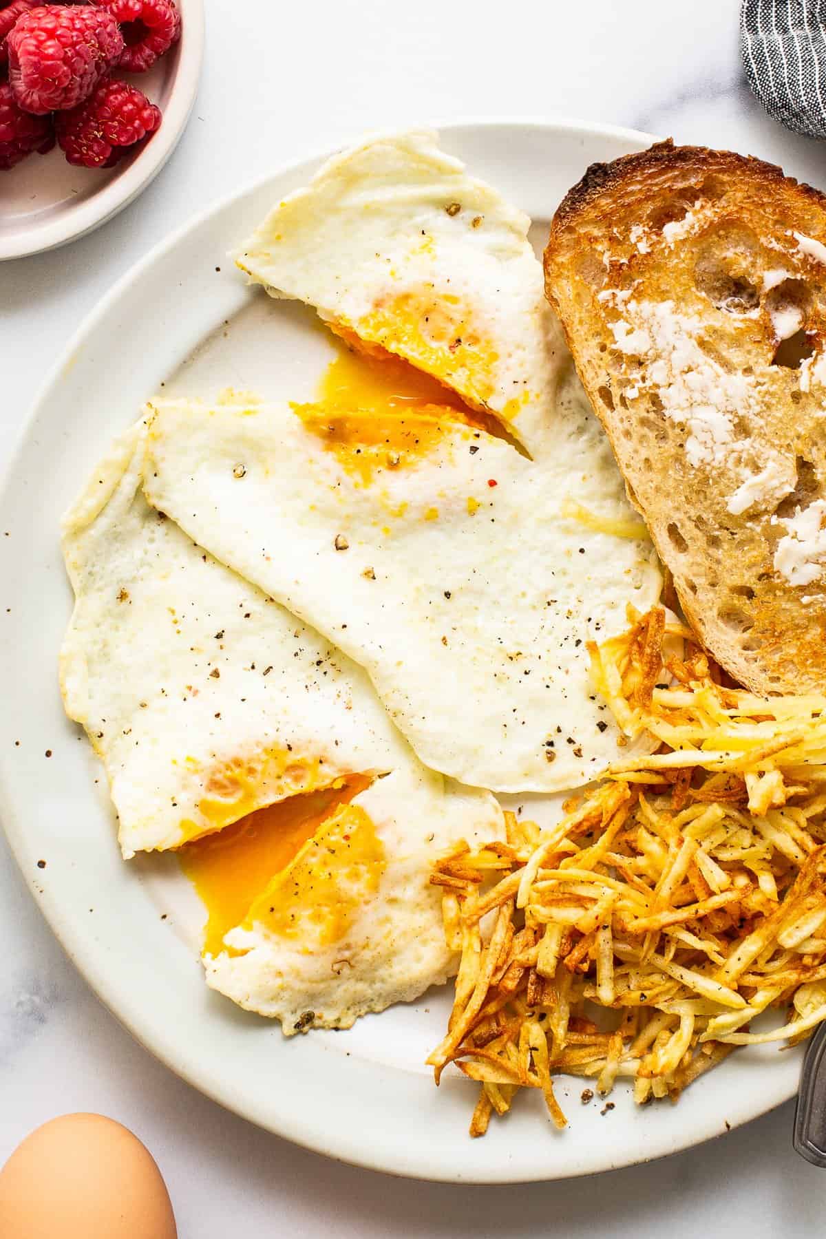 Over medium eggs on a plate with toast.
