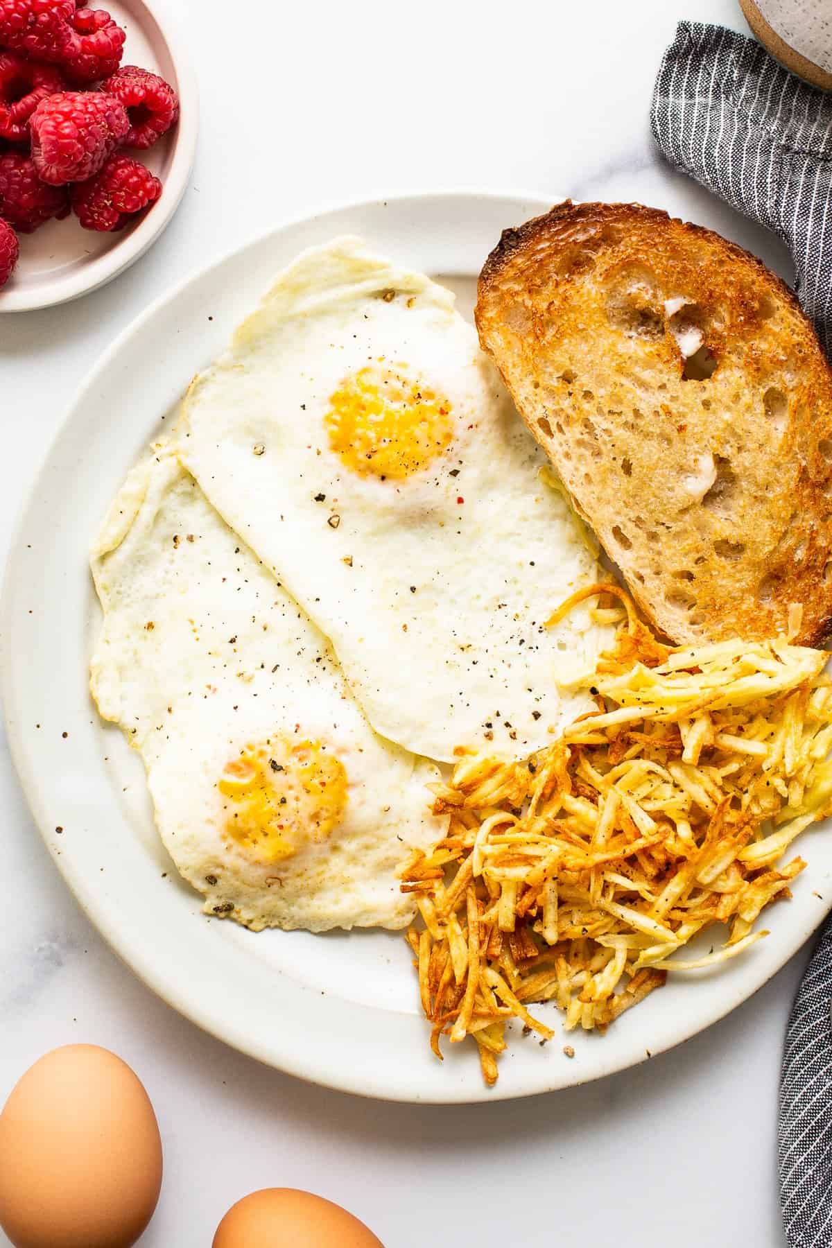 Over medium eggs on a plate with toast.