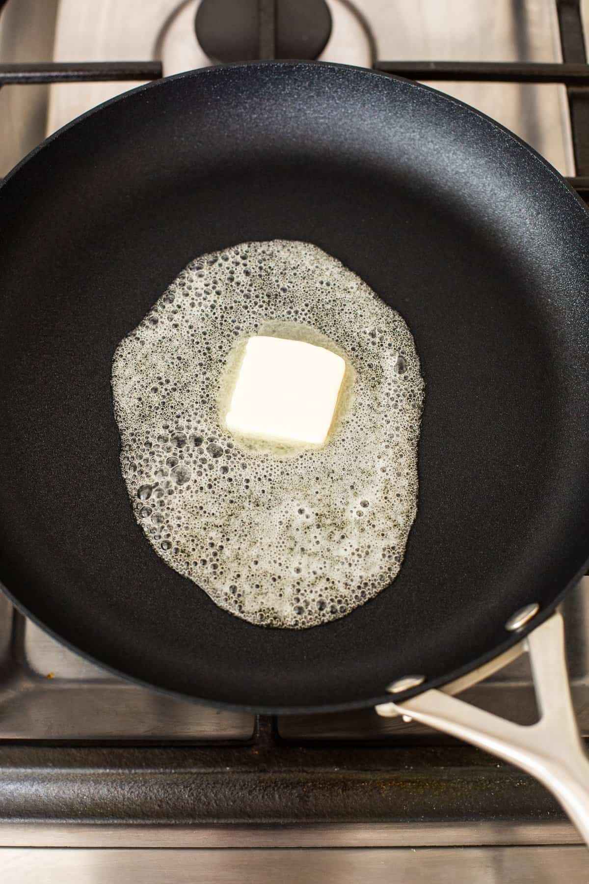 Butter melting in a skillet.