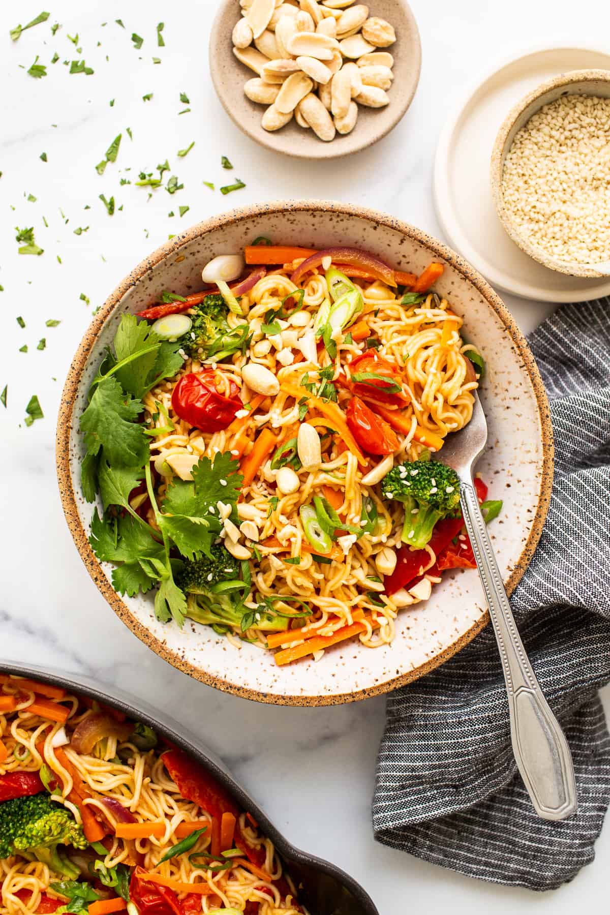 Peanut butter noodles with veggies in bowl.