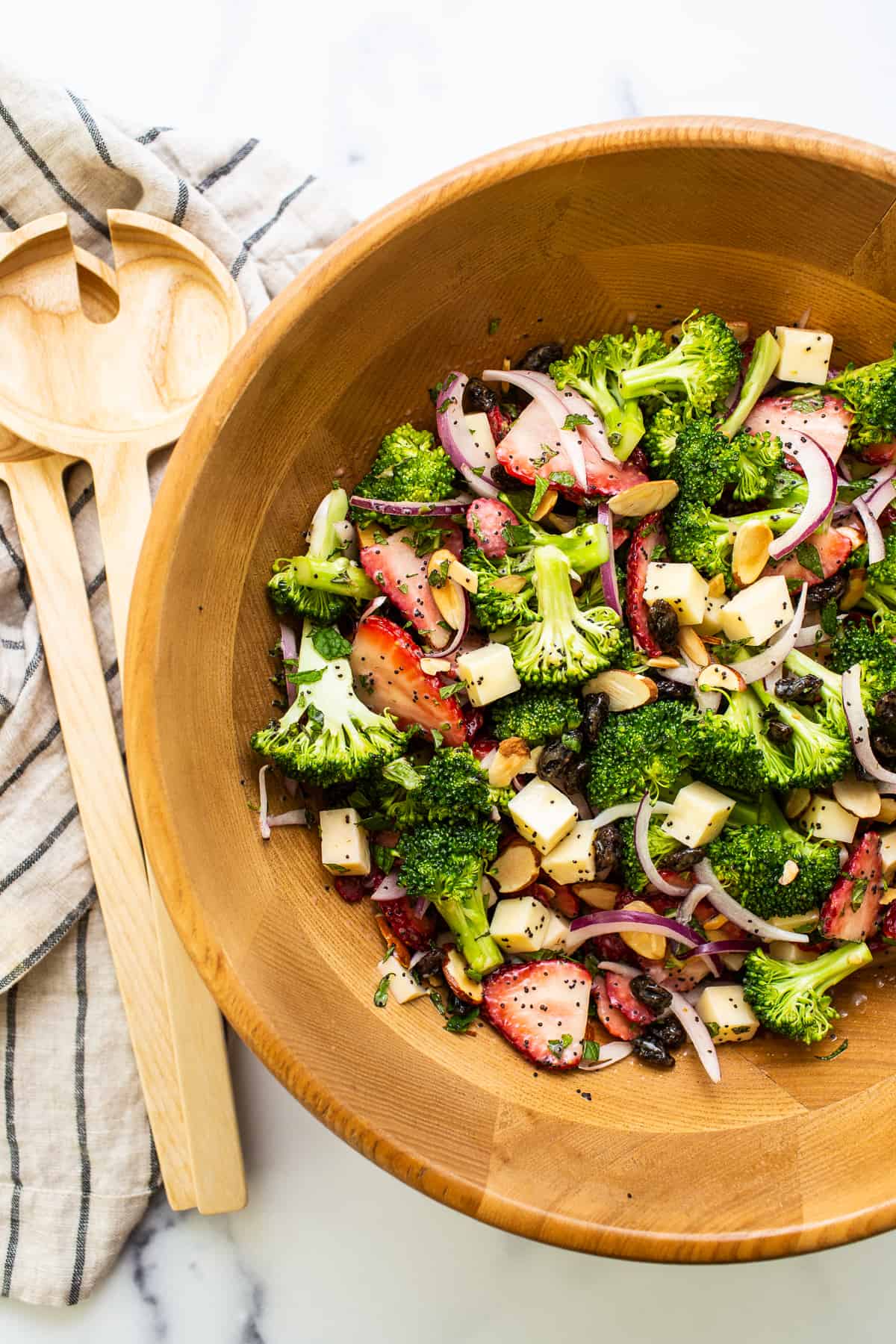 Strawberry broccoli salad in a wooden bowl.