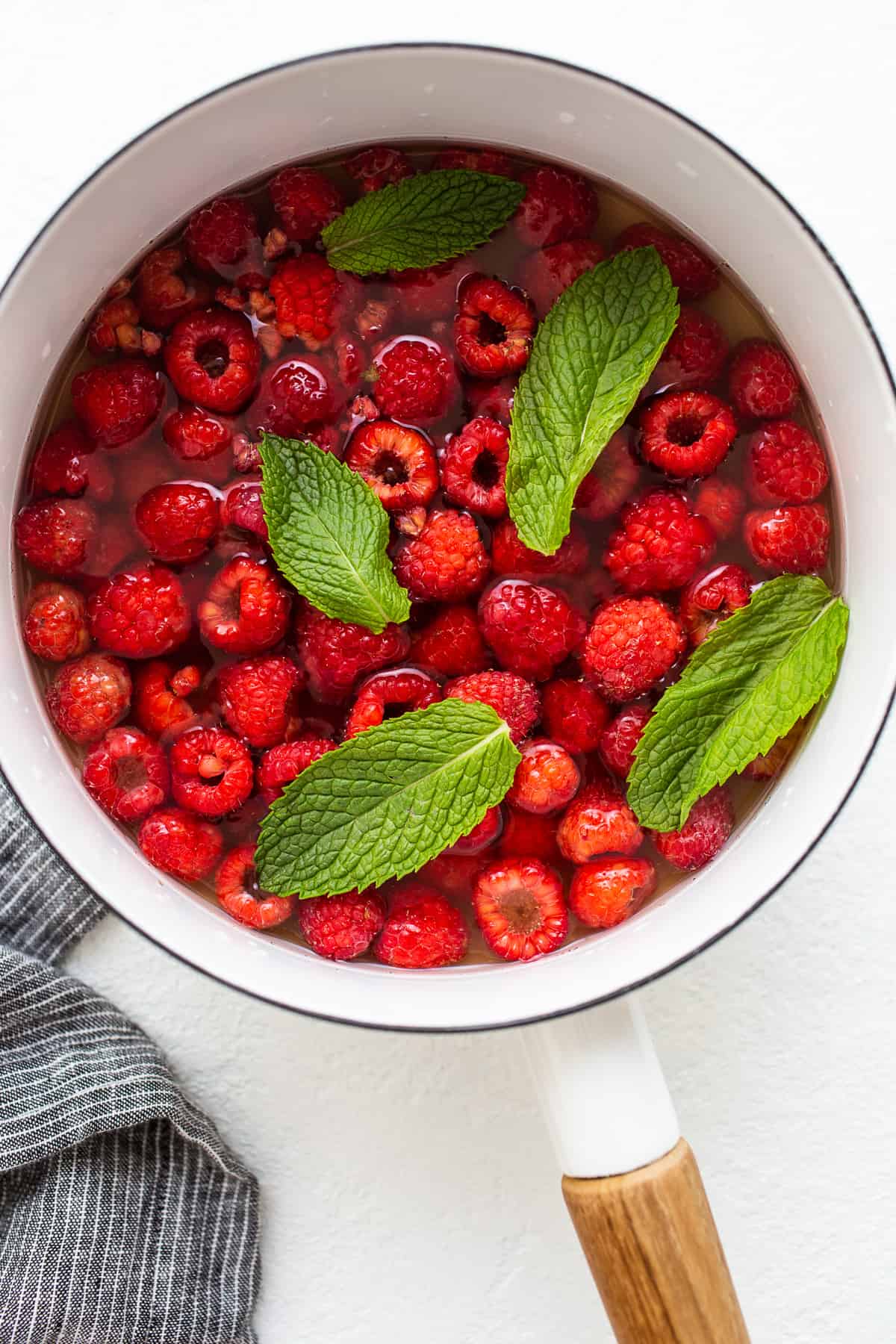 raspberries simmering in water and honey.