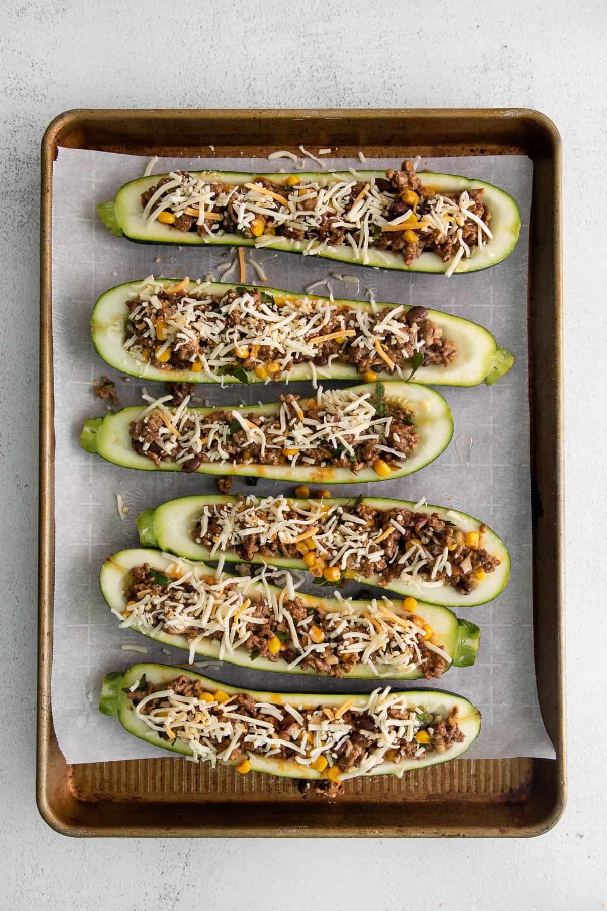 stuffed zucchini on baking sheet.