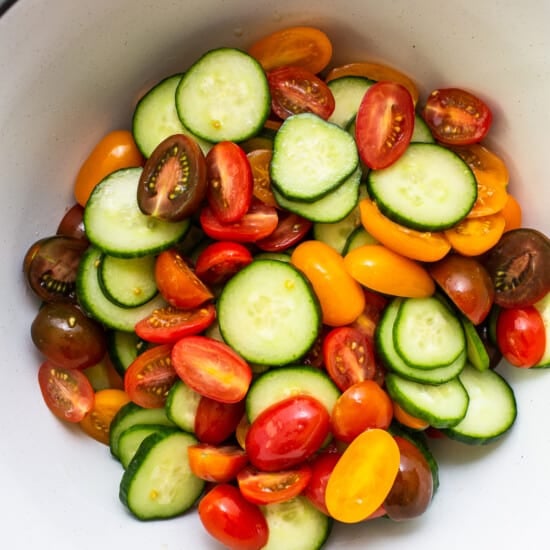 Salted tomatoes and cucumbers in a bowl.