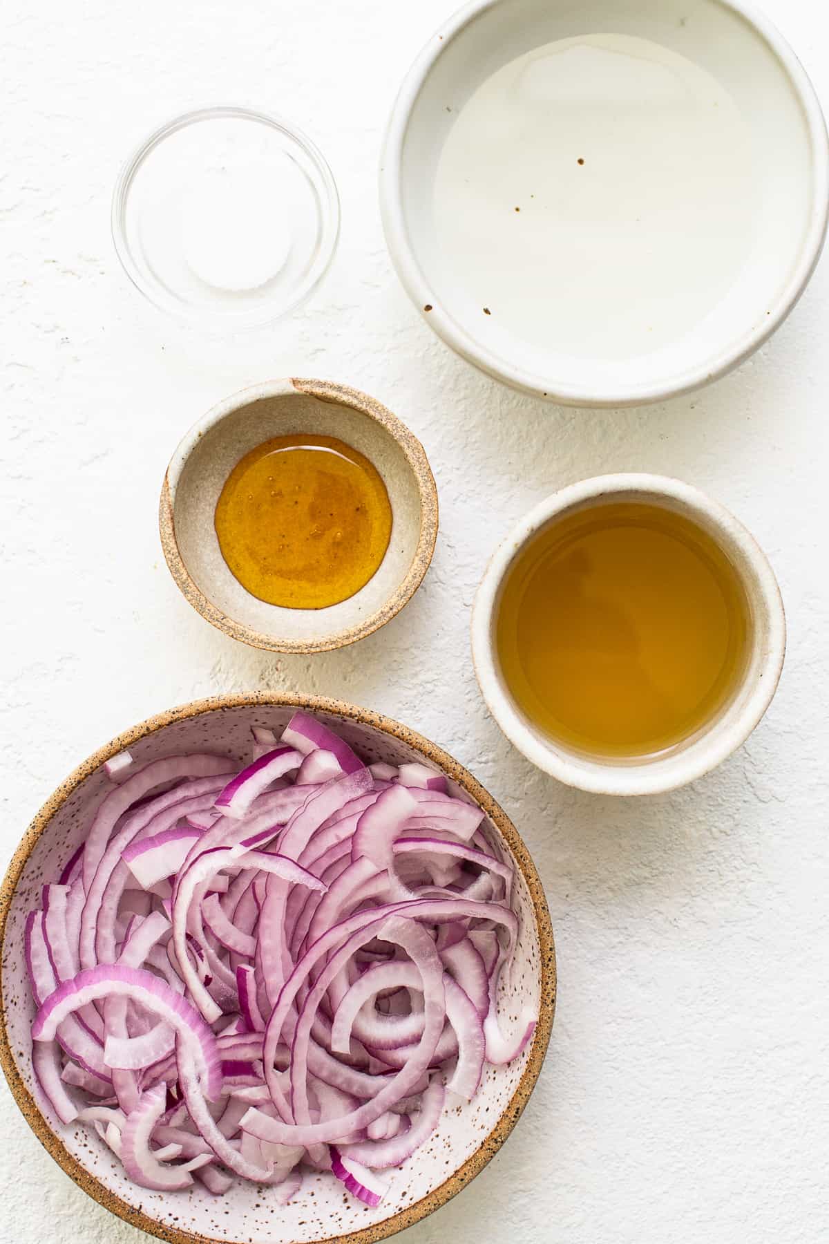 Ingredients for the cucumber tomato salad in small bowls. 