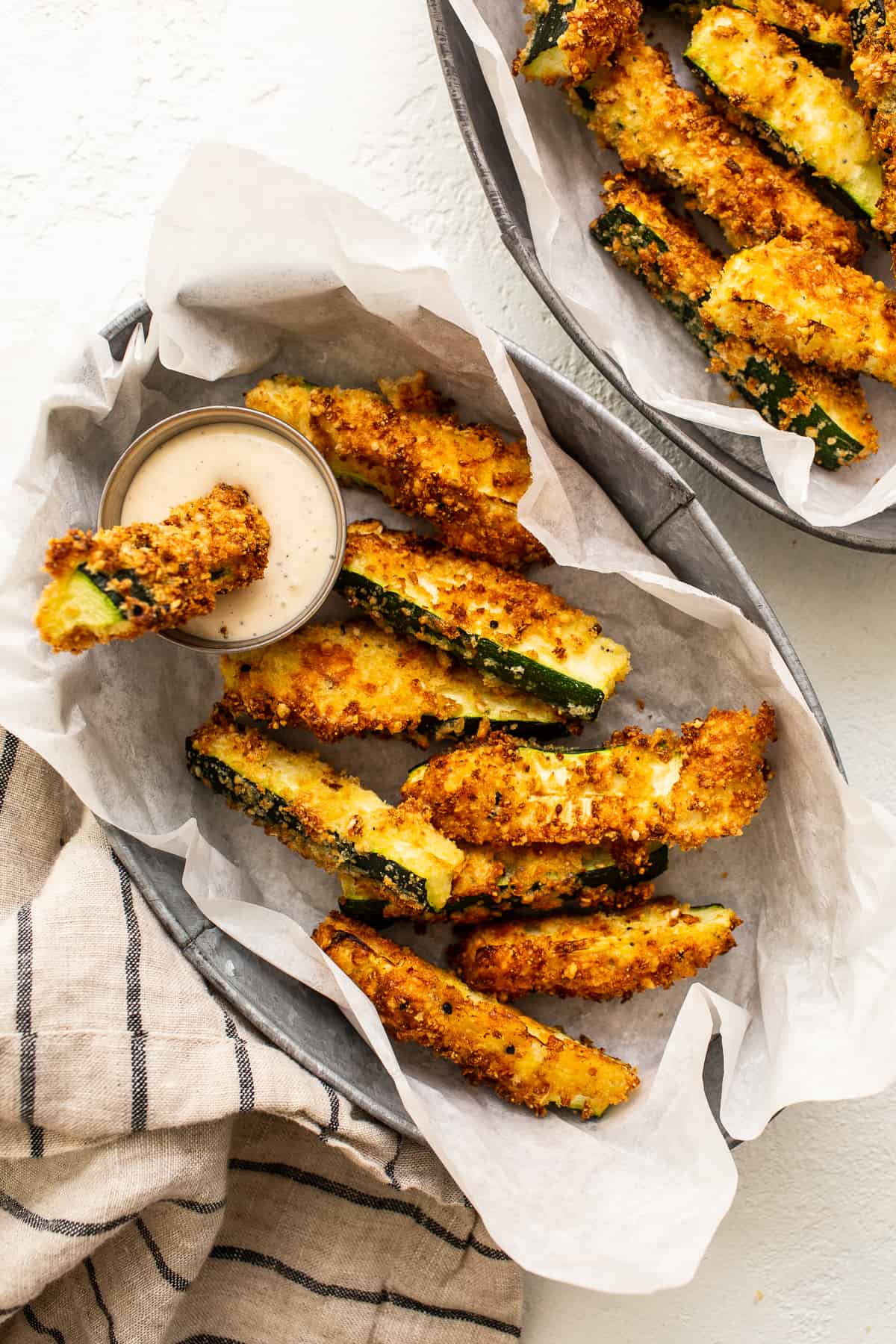 These crunchy air fryer zucchini fries are the only way you'll ever want to cook zucchini again made with a parmesan and panko breading! zucchini fries in basket.