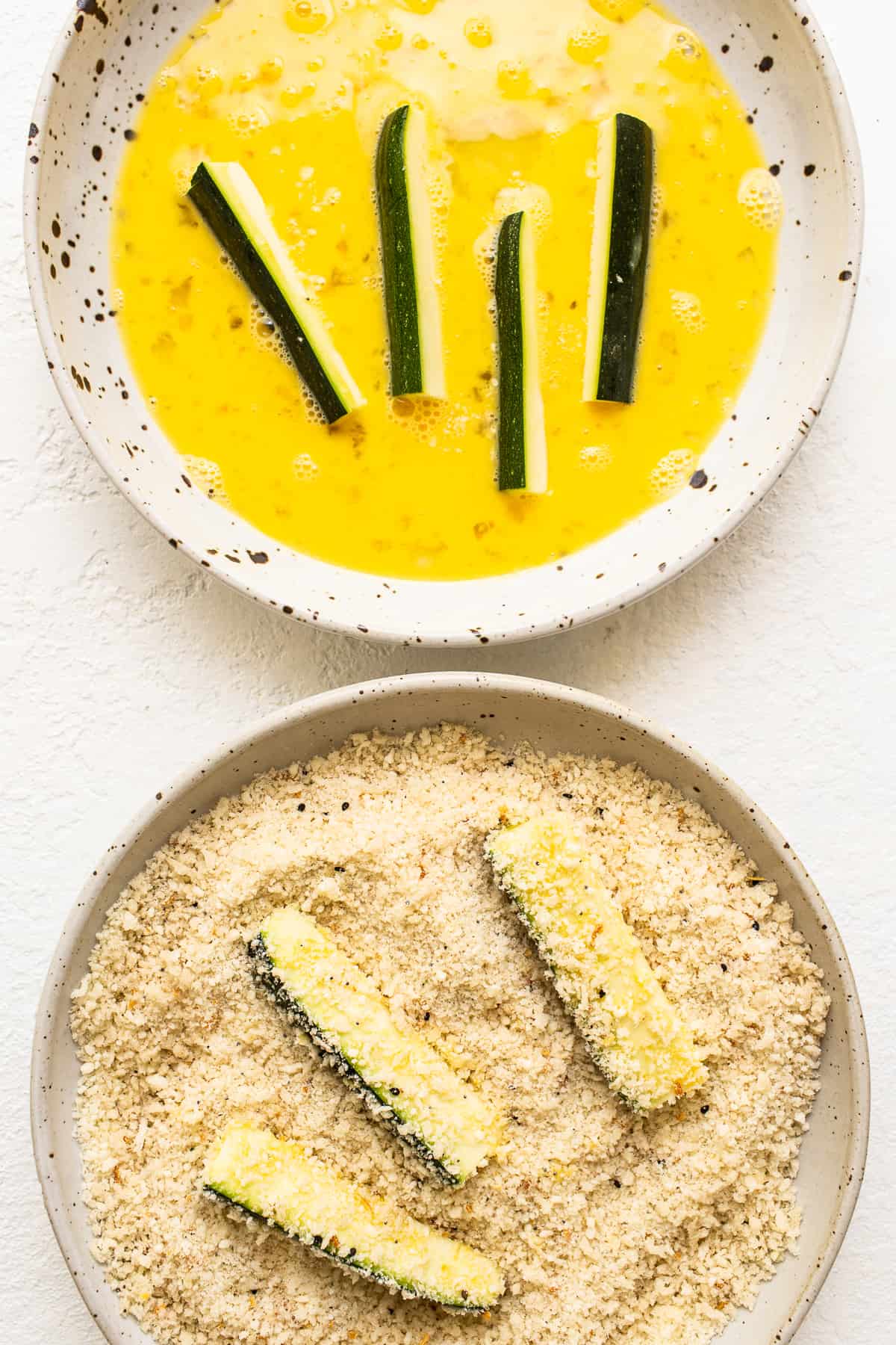 dipping zucchini in panko.