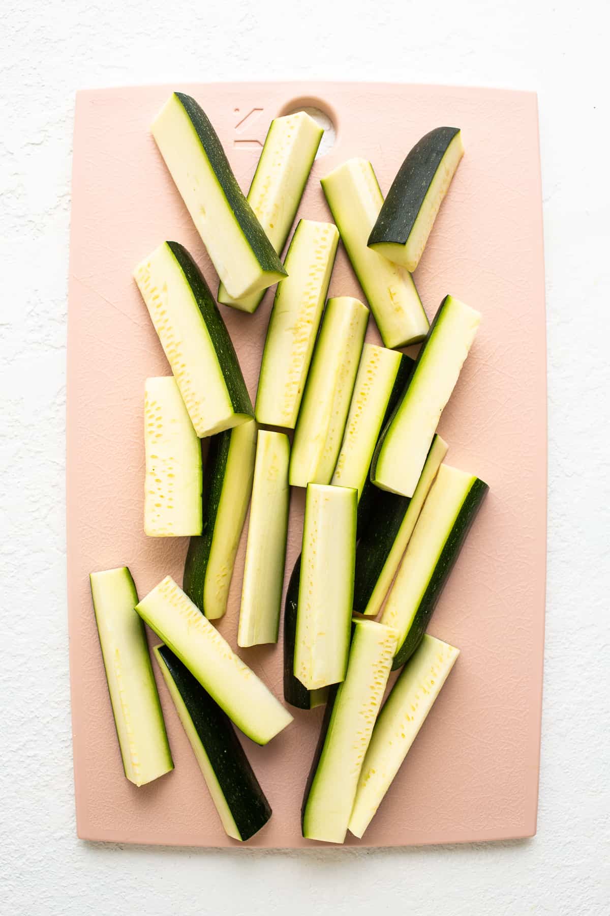 zucchini spears on cutting board.