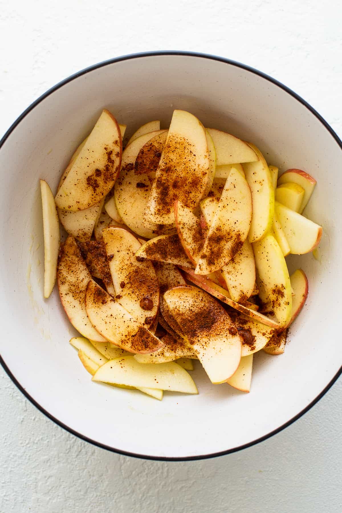 Apples and spices in a bowl.