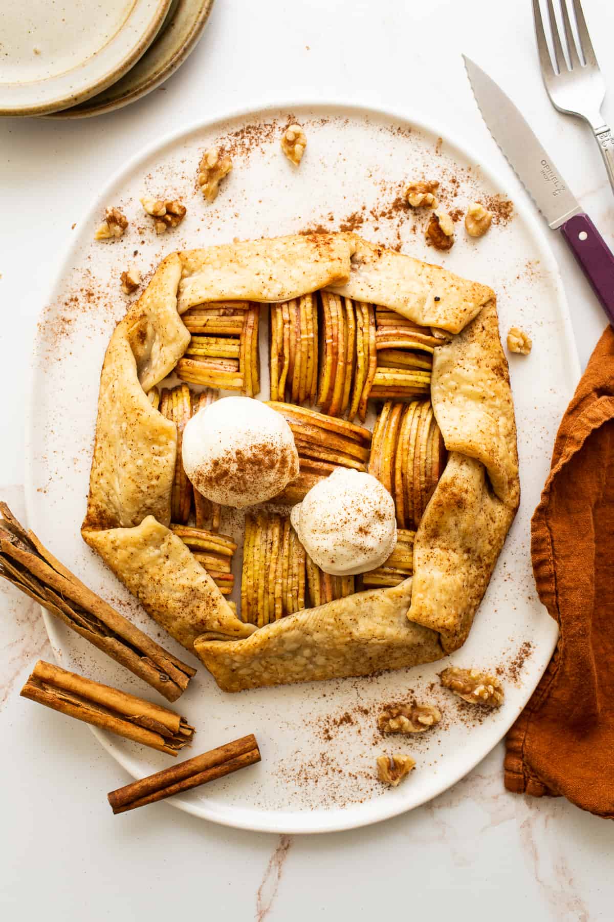 Apple galette with ice cream on platter.