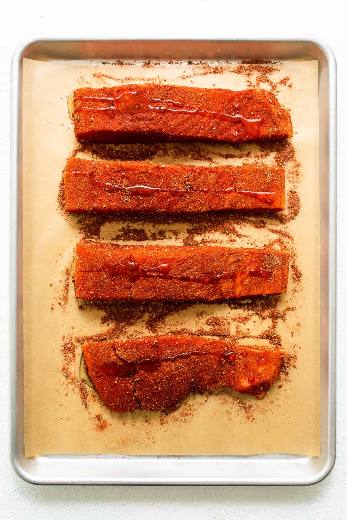 Salmon filets with seasoning and oil. 