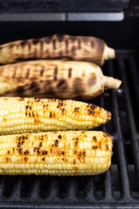 grilling corn on grill.