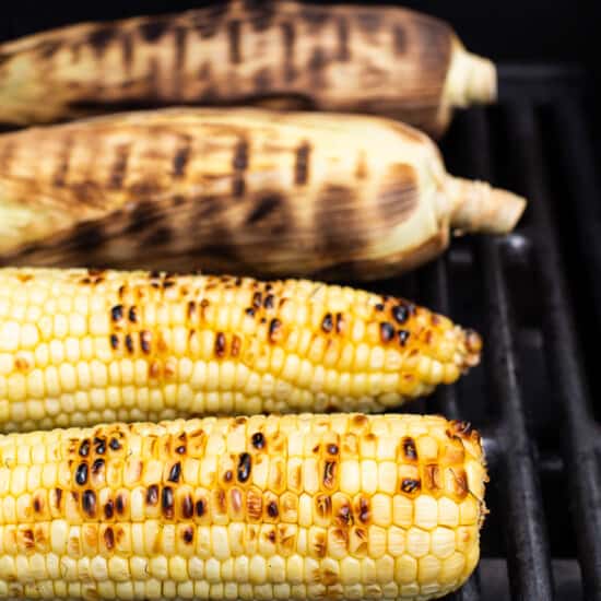 grilling corn on grill.