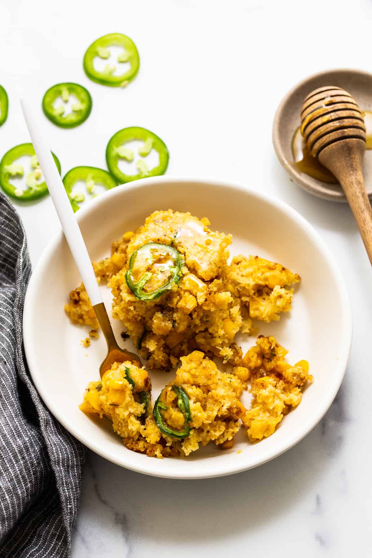 Jalapeno corn pudding in a bowl with a fork.